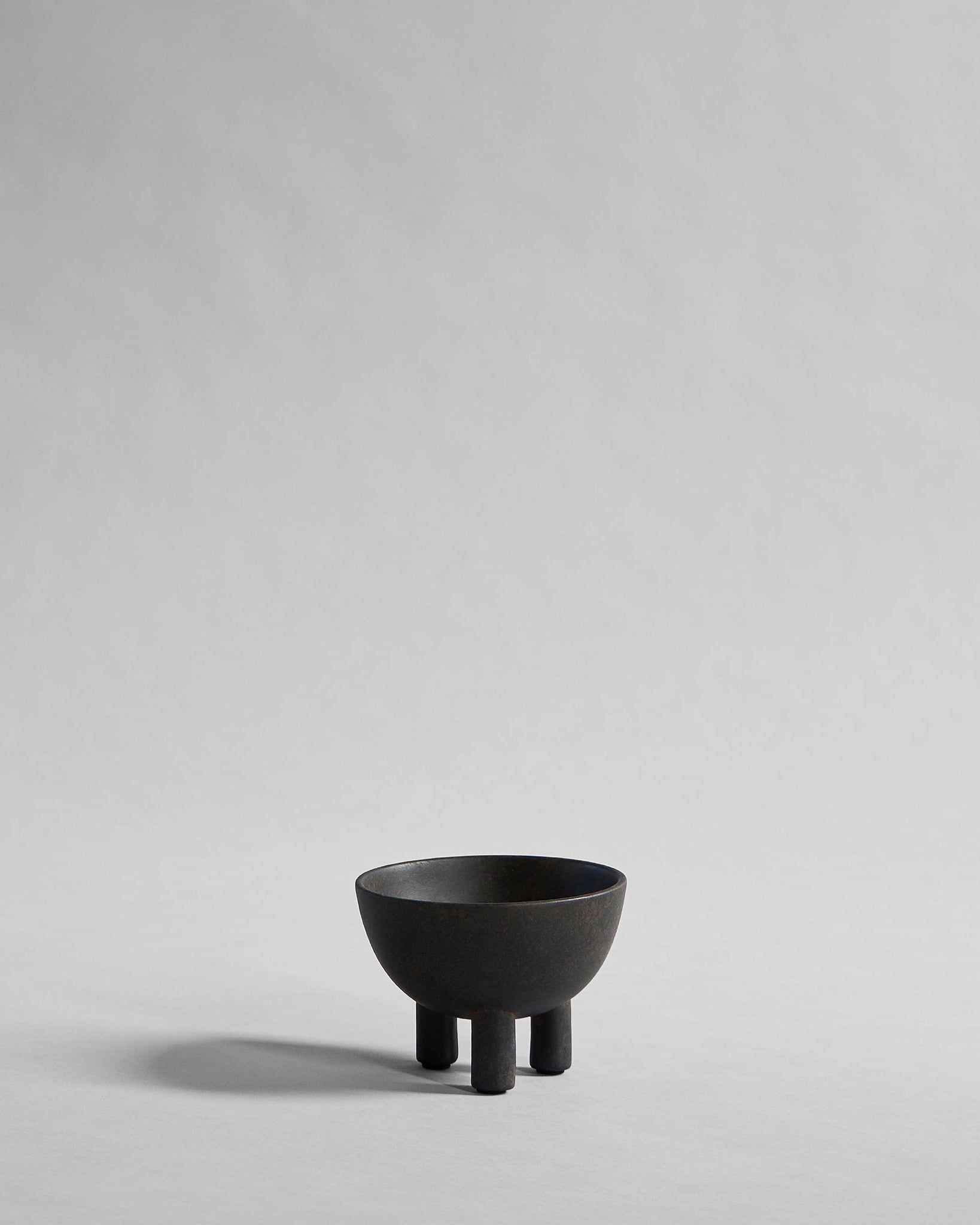 Black ceramic bowl on a gray background