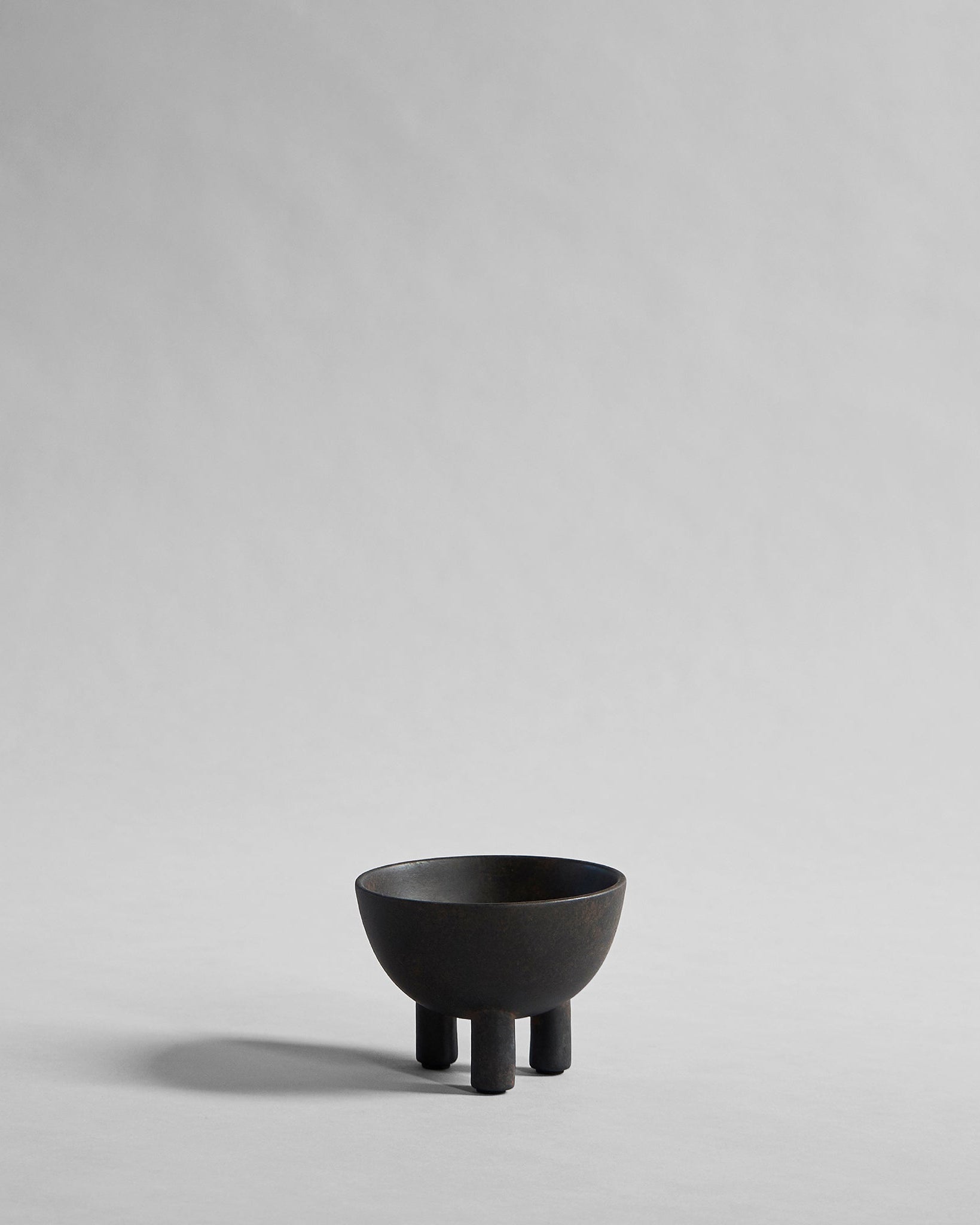 Black ceramic bowl on a gray background