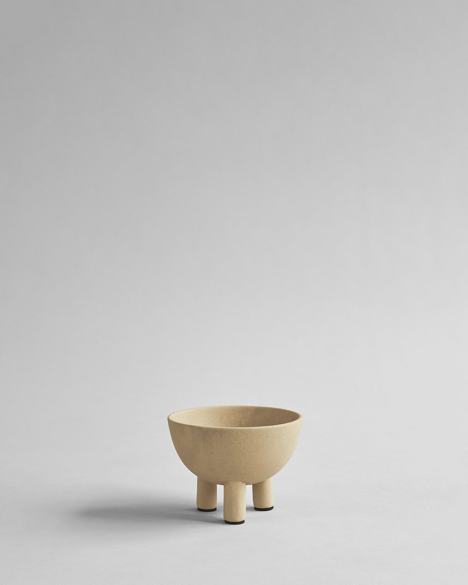 Beige ceramic bowl on a light gray background