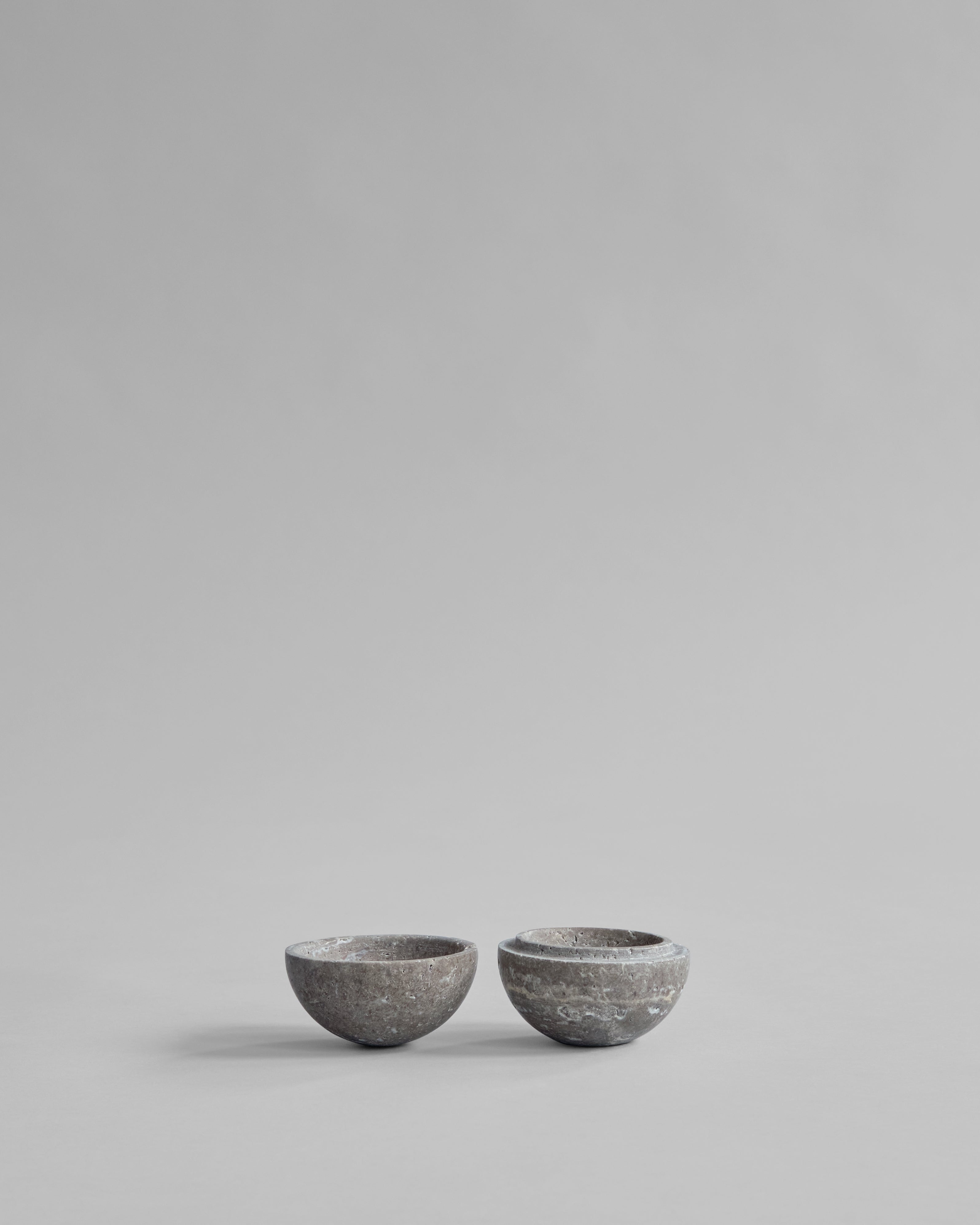 Two small gray ceramic bowls on a light gray background