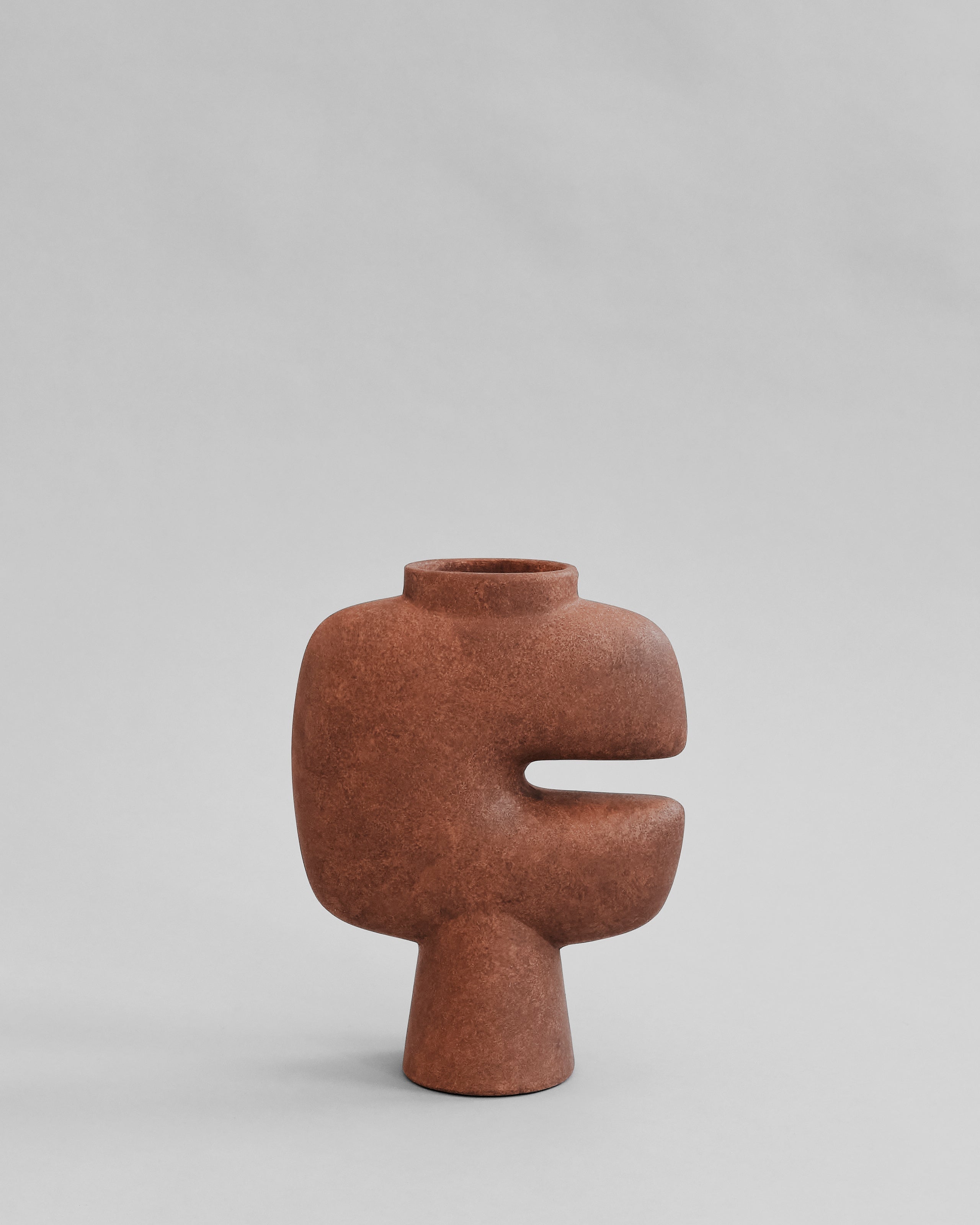 Brown abstract vase on a light gray background