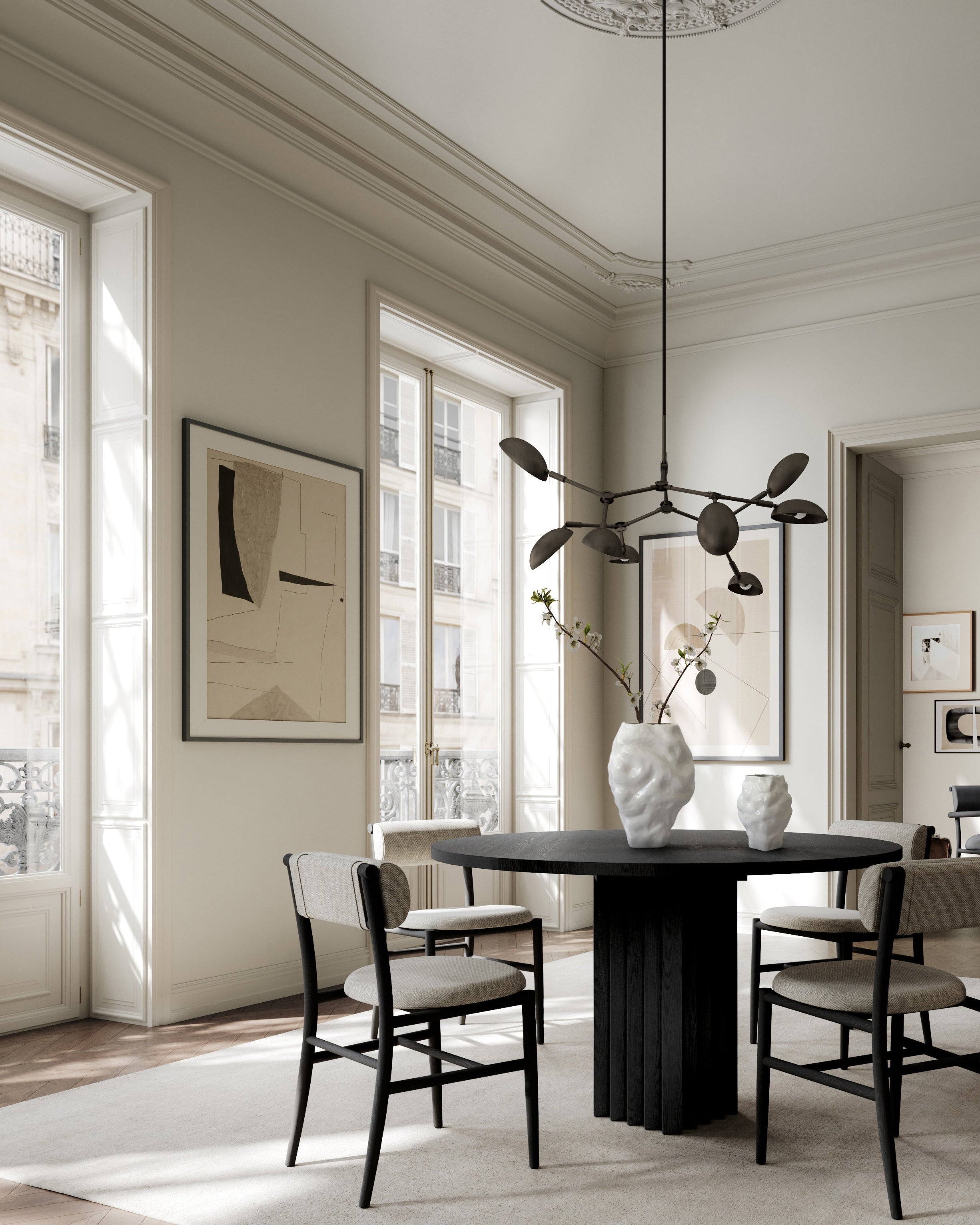 Modern dining room with a black table and chairs, white walls, and large windows. Katachi Vase, Medio by 101 Copenhagen. Sculptural vase inspired by Japanese “shape”, available in High Glaze Birch ceramic and Clear or Smoked Forest mouth-blown glass. Fully waterproof – curated by Numa Home.