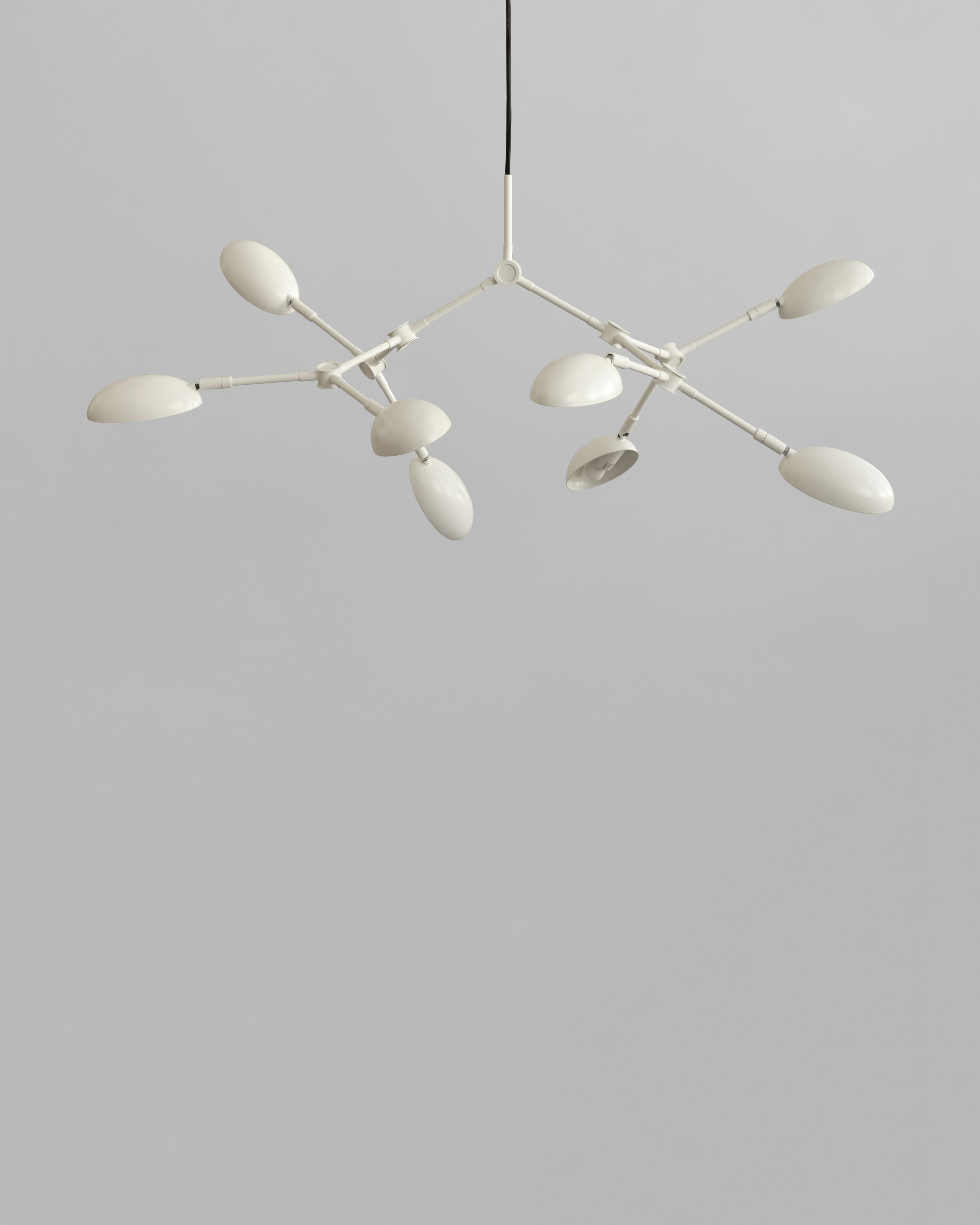 Modern chandelier with white lampshades on a gray background