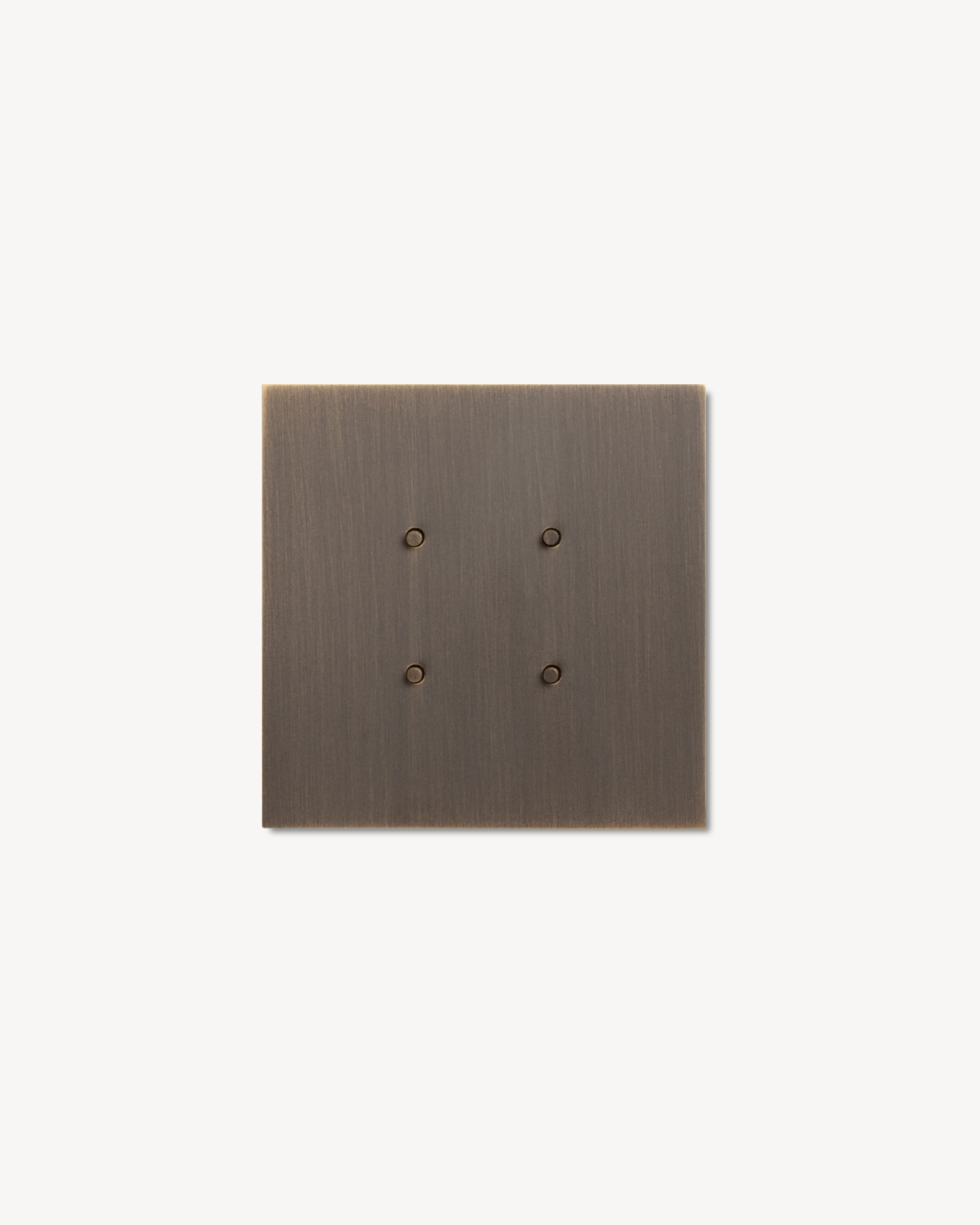 Bronze-colored square switch with four buttons on a white background