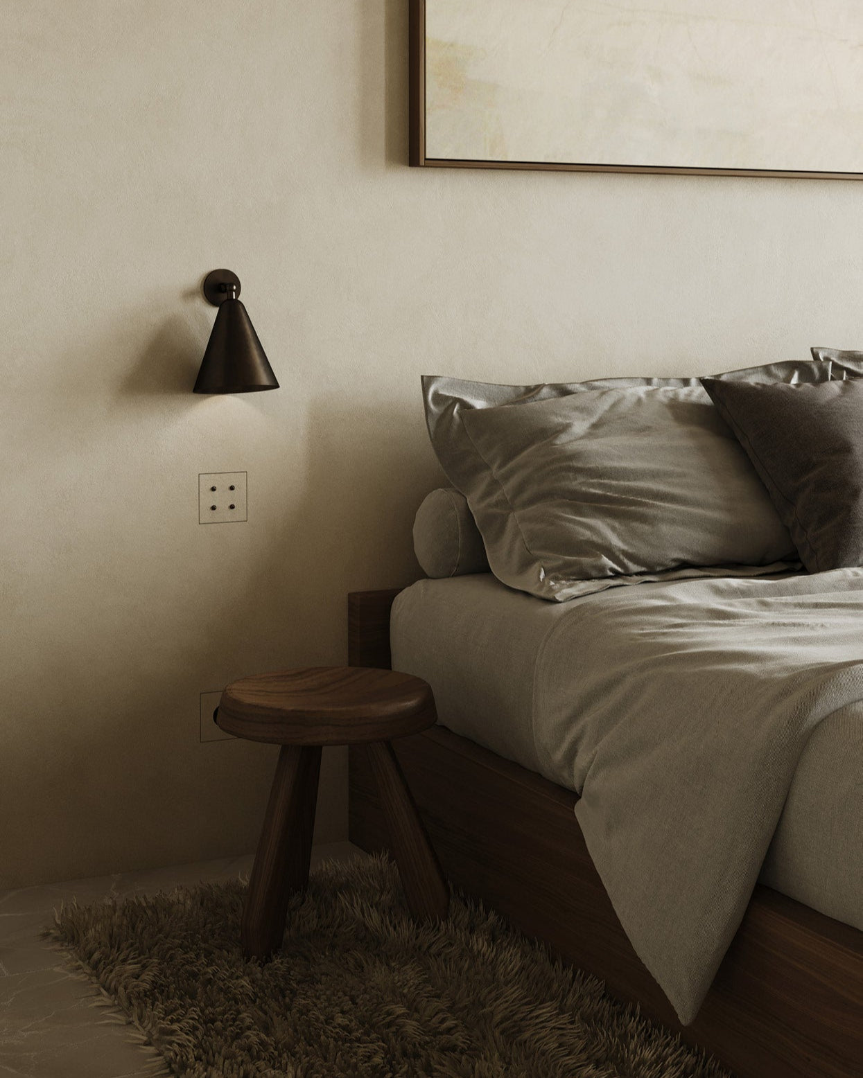 Bedroom with a wooden stool, bed with pillows, and a wall sconce. Mata 4 button switch and signe outlet, socket seamlessly integrated into the wall plaster. Red Dot Design Award-winning design by Studio Straff and Sumum. Curated by Numa Home for the Netherlands and Turkiye market.