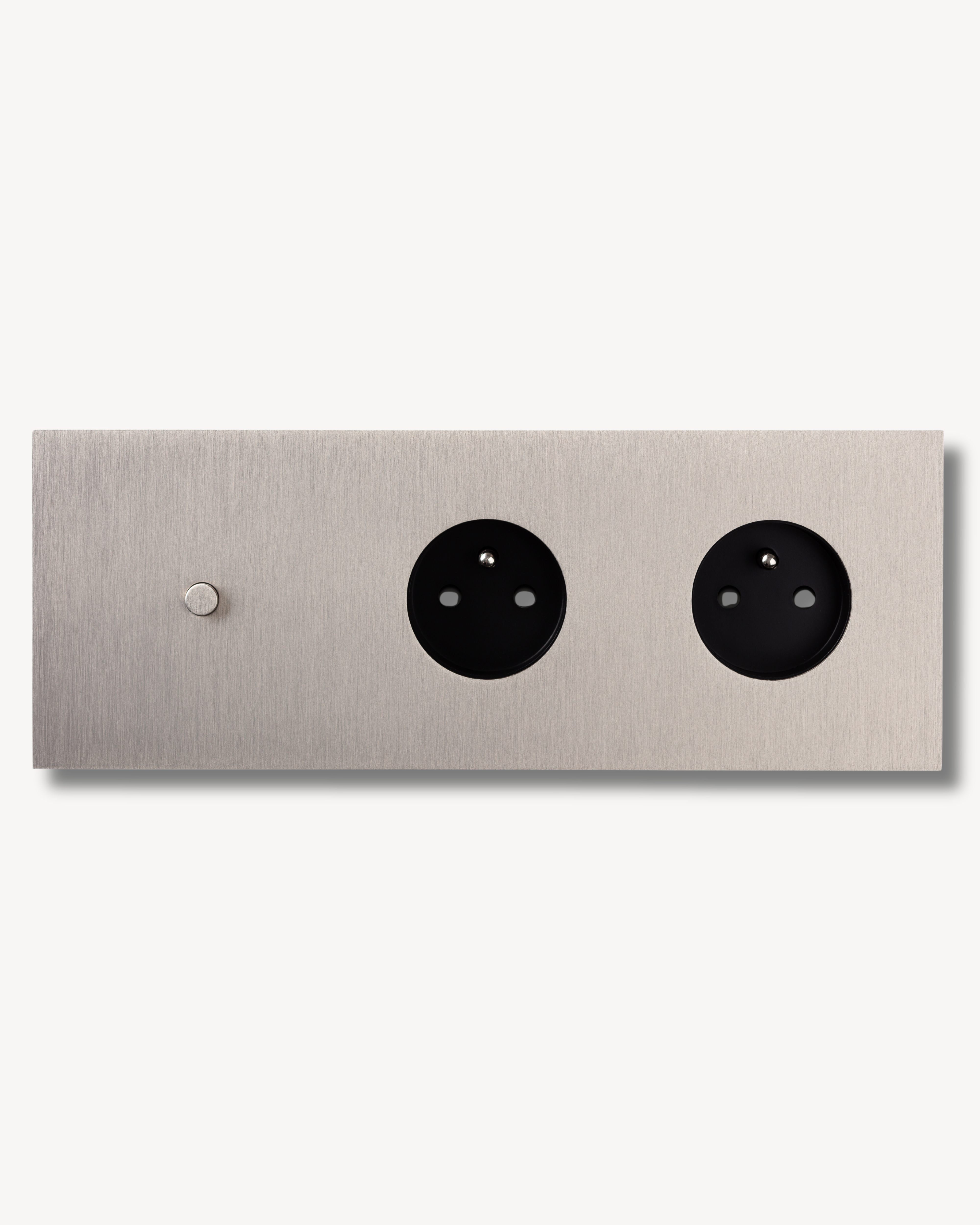 Brushed metal finished brass electrical switch plate with 3 units. Single oush button and double outlets.