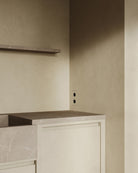MATA recessed double power outlet seamlessly integrated into a beige plastered kitchen wall with matching countertop and shelf – Sumum x Studio STRAF.