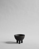 Black ceramic bowl on a gray background