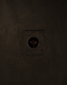 MATA recessed single power outlet seamlessly integrated into a dark textured plaster wall – Sumum x Studio STRAF. This socket is curated by Numa Home for the Netherlands and Türkiye.