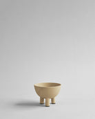 Beige ceramic bowl on a light gray background