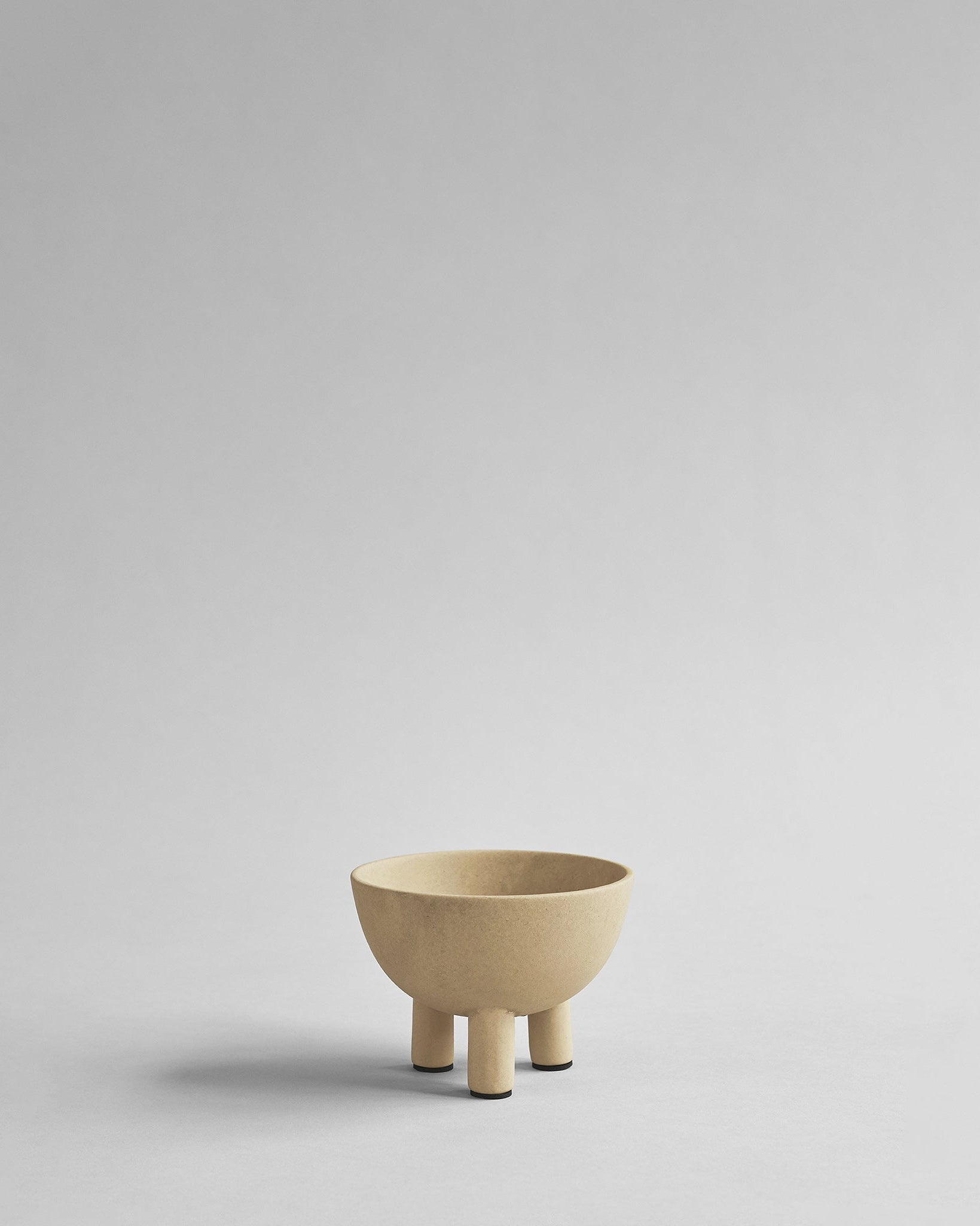 Beige ceramic bowl on a light gray background