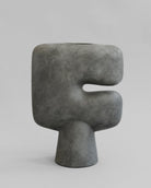 Gray abstract sculpture on a light gray background