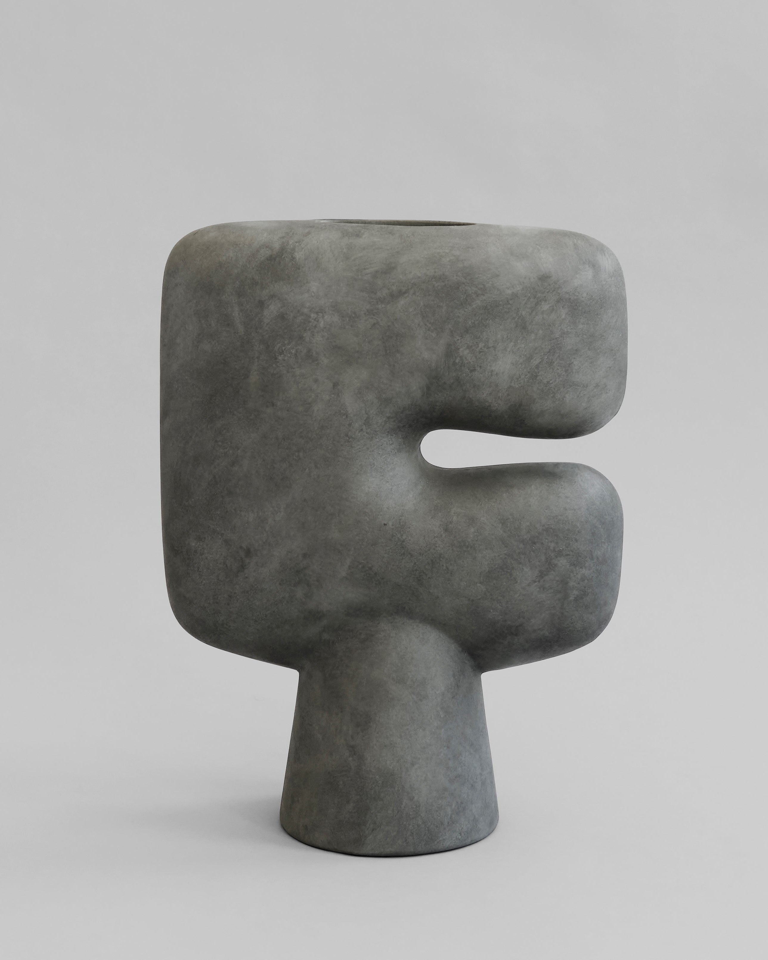 Gray abstract sculpture on a light gray background