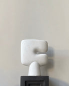 Abstract white sculpture on a gray background. Tribal sculprural vase