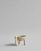 Beige ceramic bowl on a light gray background