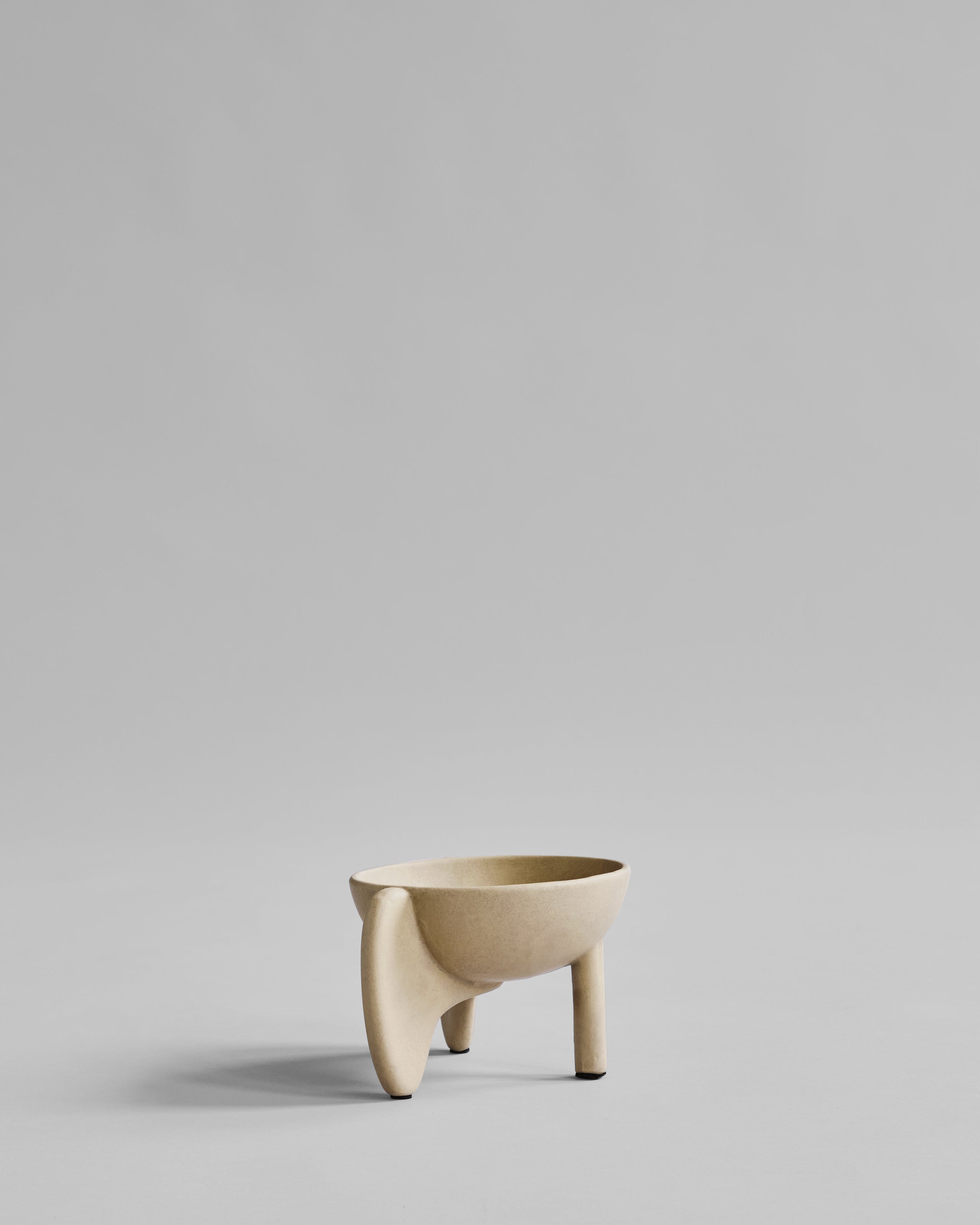 Beige ceramic bowl on a light gray background