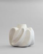 White ceramic Wabi vase big by 101 Copehagen with a unique, organic shape on a gray background