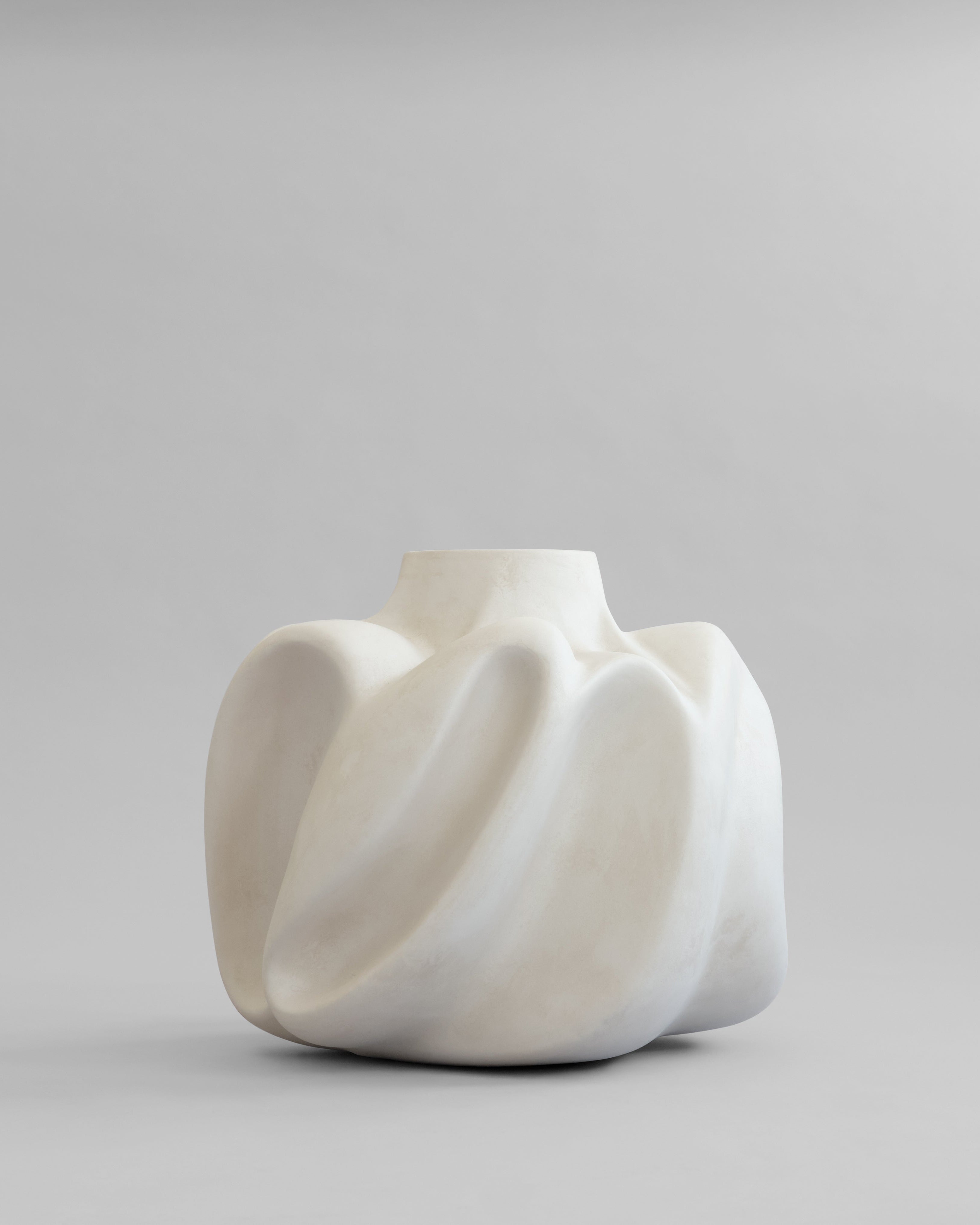 White ceramic Wabi vase big by 101 Copehagen with a unique, organic shape on a gray background