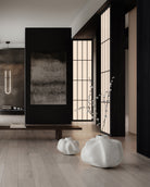 Modern interior with abstract art, white vases, and a light fixture.