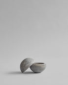 Concrete bowl with a matching lid on a light gray background