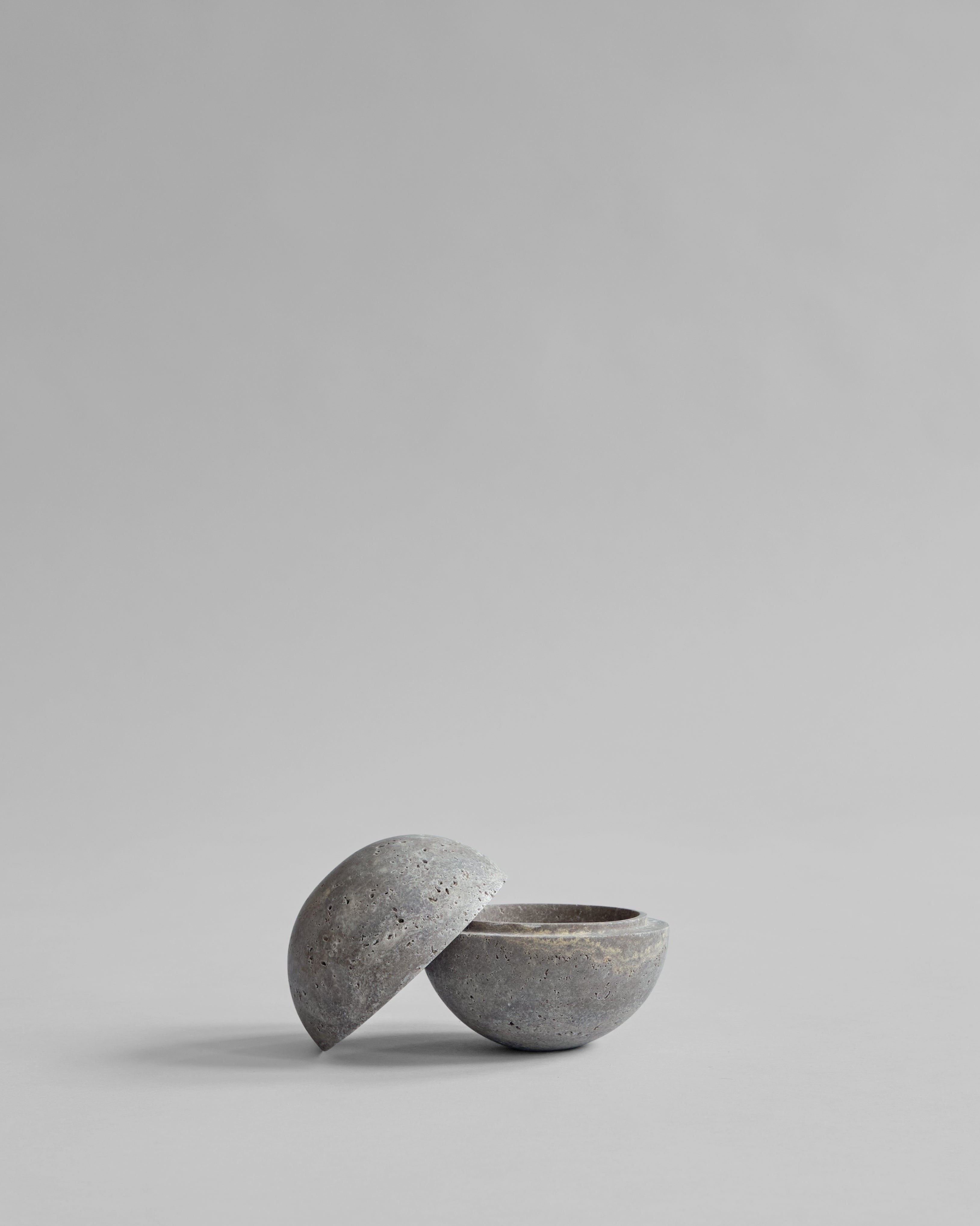 Concrete bowl with a matching lid on a light gray background
