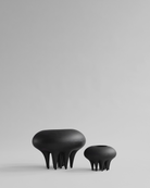 Two black, organic-shaped vases on a light gray background. Medusa Vase, Big by 101 Copenhagen. Sculptural ceramic vase with soft oval shapes and small conical legs, hand-glazed in Coffee. Curated by Numa Home for calm, modern interiors.