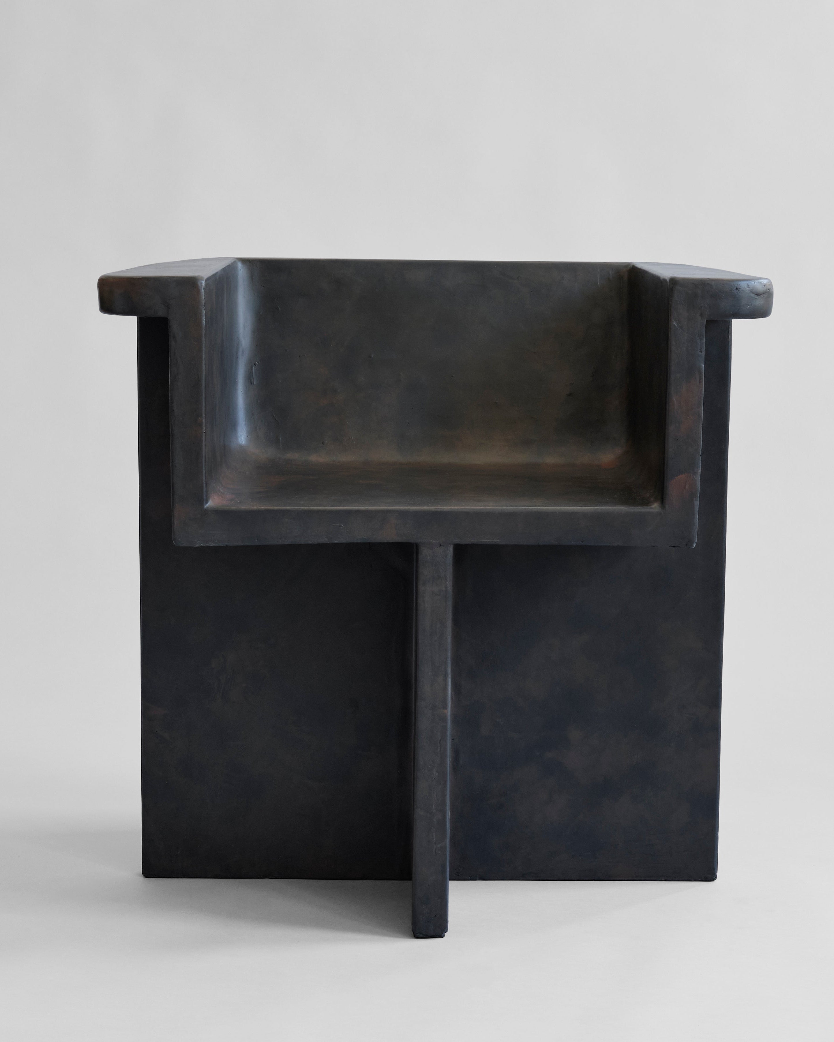 Black stone-like dining chair on a light gray background. 101 Copenhagen Brutus Dining Chair, Curated by Numa Home