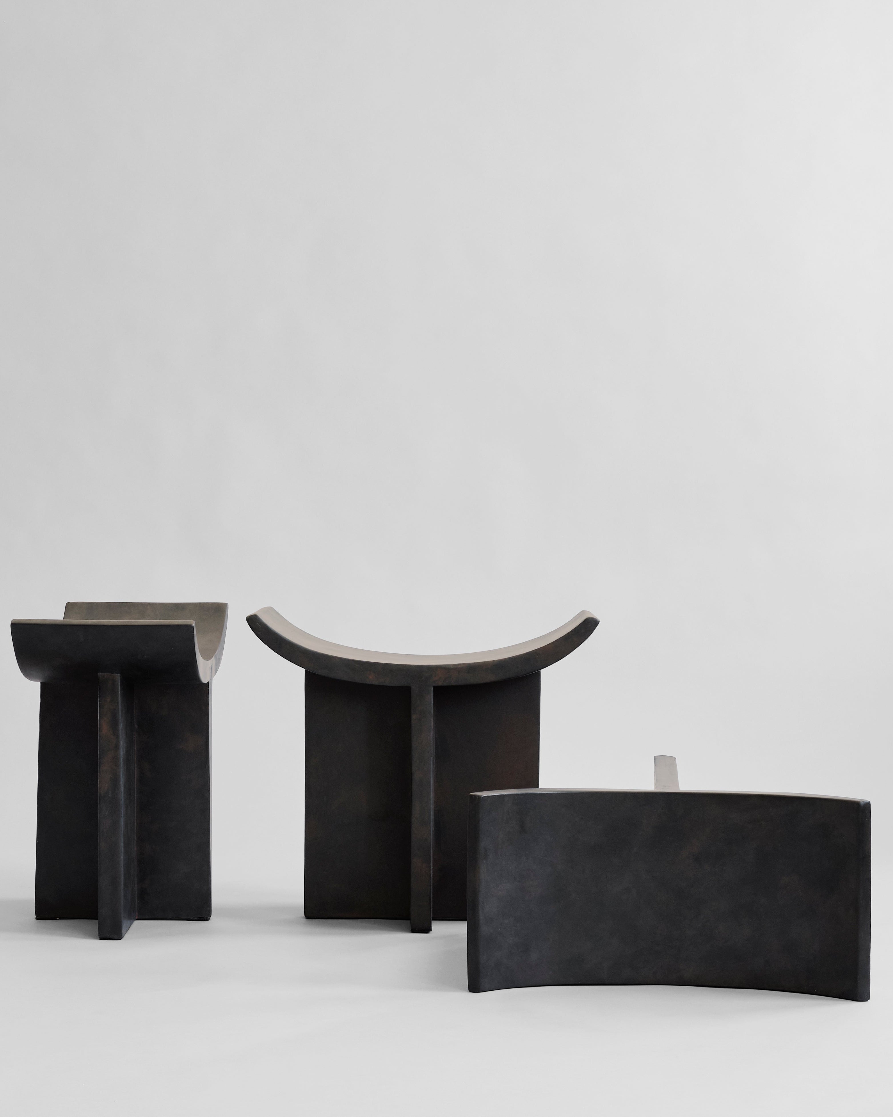 Three black stone like benchs on a white background. 101 Copenhagen Brutus Stool curated by Numa Home