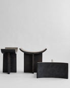 Three black stone like benchs on a white background. 101 Copenhagen Brutus Stool curated by Numa Home