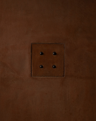 MATA recessed switch with four bullet-shaped button, seamlessly integrated into a clay cloured and rough textured plaster wall – Sumum x Studio STRAF. Curated by Numa Home for the Netherlands and Turkey