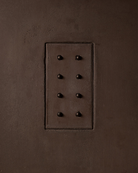 MATA recessed switch with eight bullet-shaped button, seamlessly integrated into a dark clay cloured and rough textured plaster wall – Sumum x Studio STRAF. Curated by Numa Home for the Netherlands and Turkey