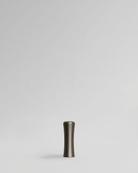Brushed nickel cabinet handle pull on light gray background. Brass cabinet handle designed by Stef Claes, created by Sumum, curated by Numa Home.