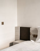 Sumum Square antique-bronze double push button and four-button switch paired with Read-S brass reading light in a custom headboard, premium hardware for luxury bedrooms provided by Numa Home