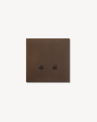 Sumum Square double-button brass switch in antique bronze (brass patina) finish premium custom light switch for high-end Dutch interiors provided by Numa Home